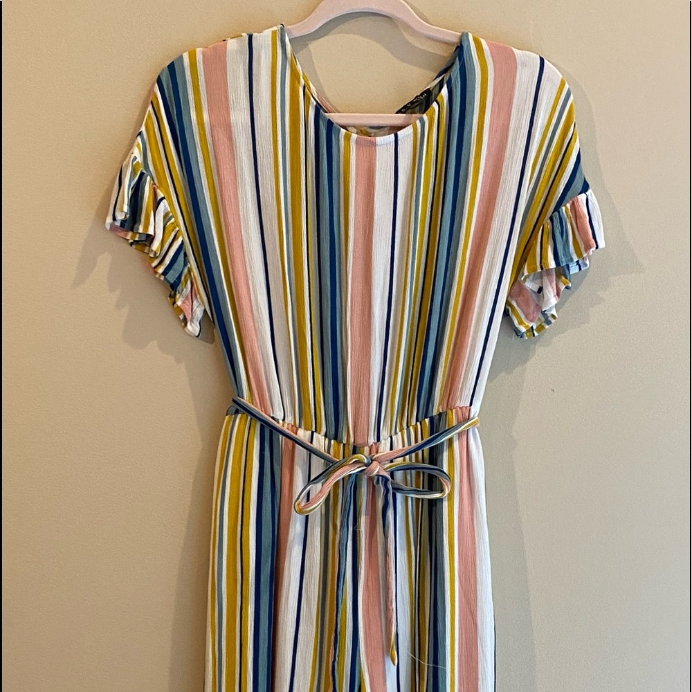 One piece jumper. Buttons in the back. Has light lining around the panty area.